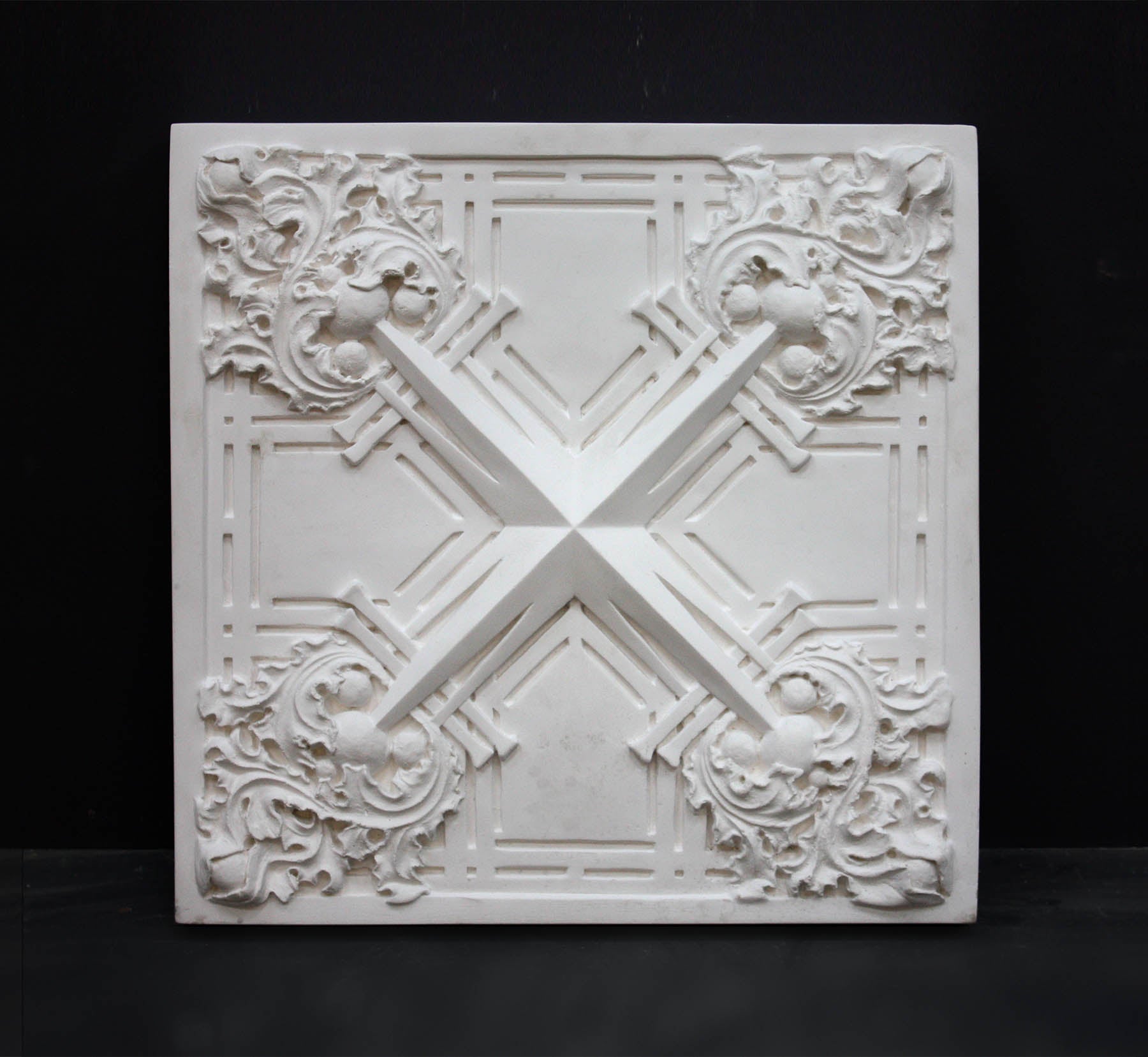 Photo of white plaster cast of architectural ornamentation detail