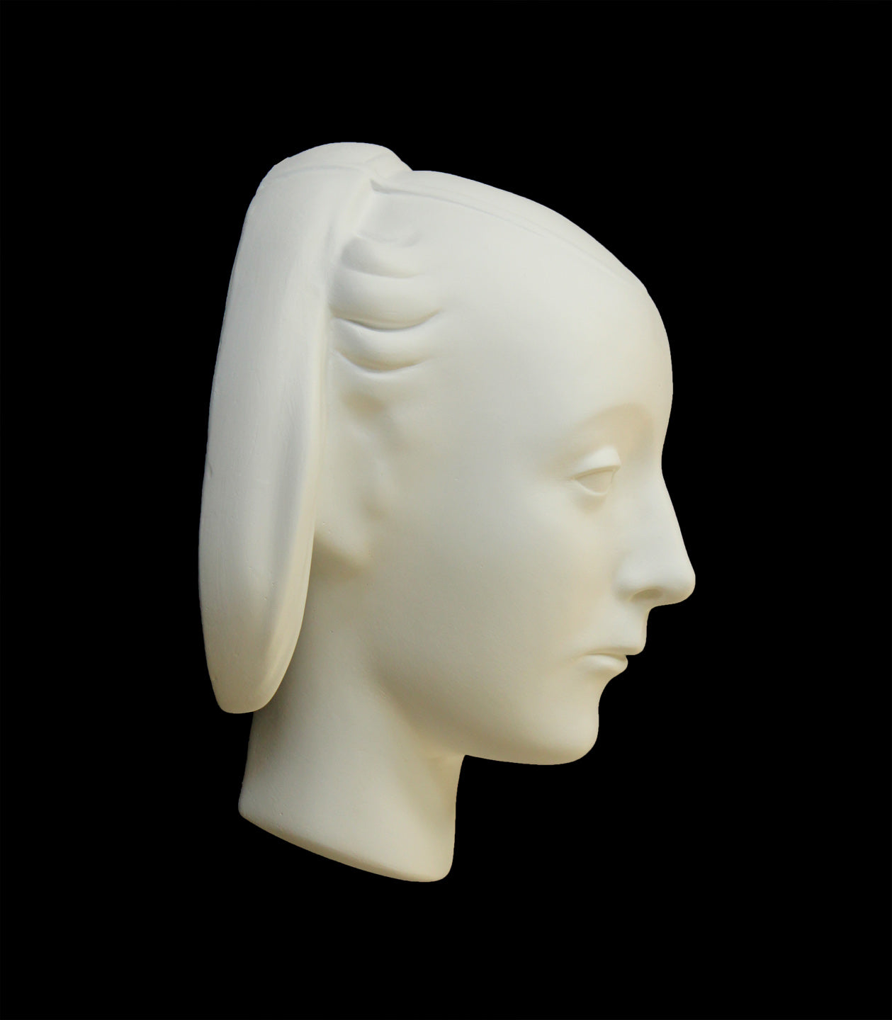 photo of white plaster cast sculpture mask of female with part-back hairdo against gray background