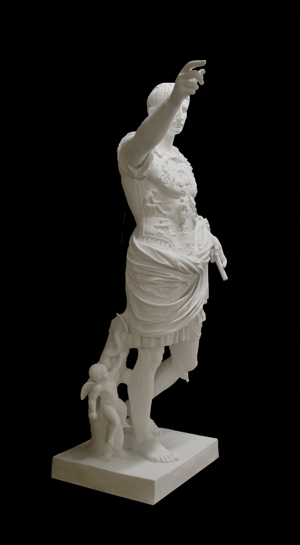 photo of white plaster cast sculpture of a man with armor and robes standing in contrapposto with his right arm raised, namely Augustus Caesar, against a black background