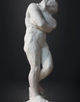 photo of white plaster cast sculpture of nude female figure hugging herself against gray background