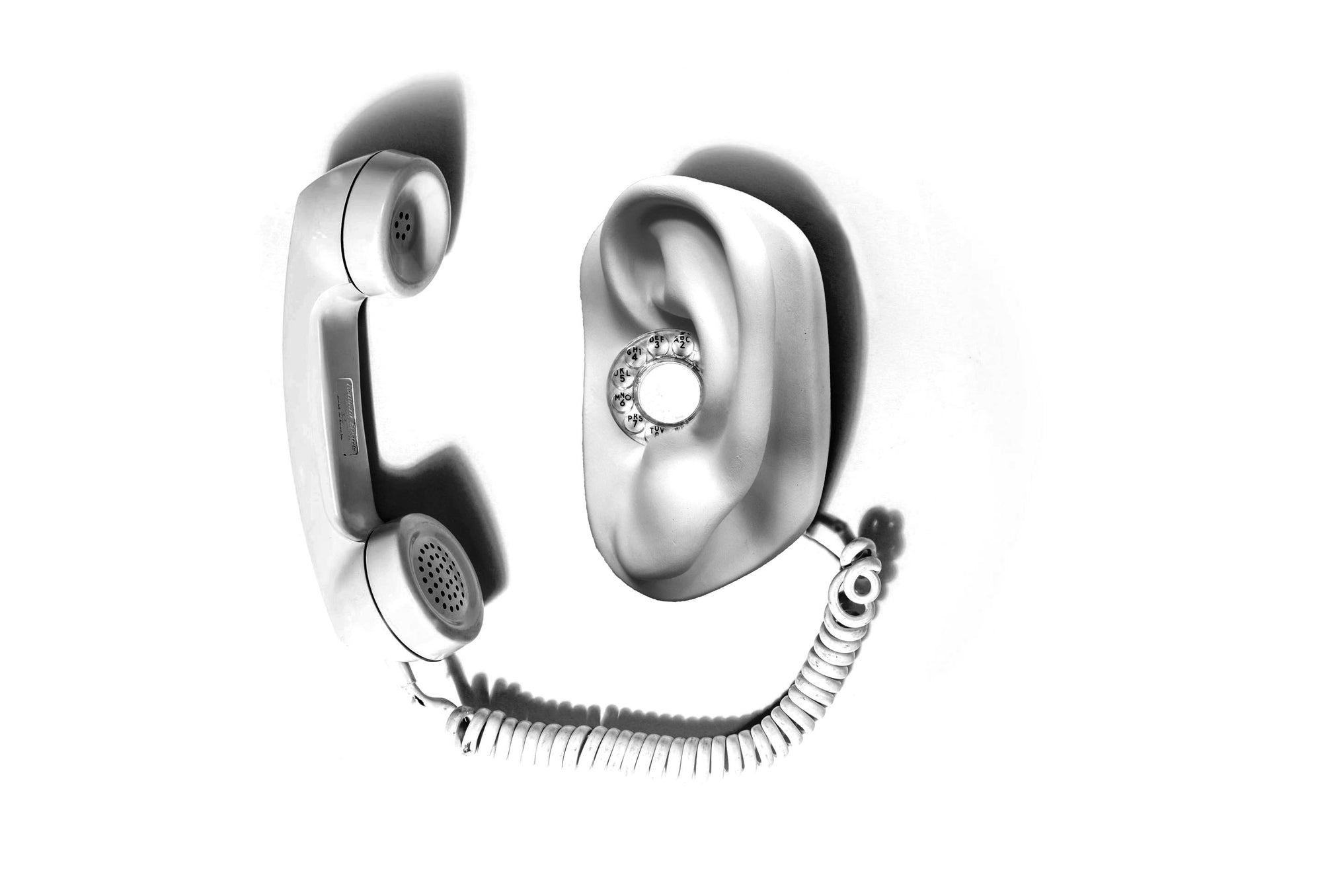 Black and white image of Michelangelo's David's ear plaster cast sculpture on panel as a rotary phone with the phone off the hook