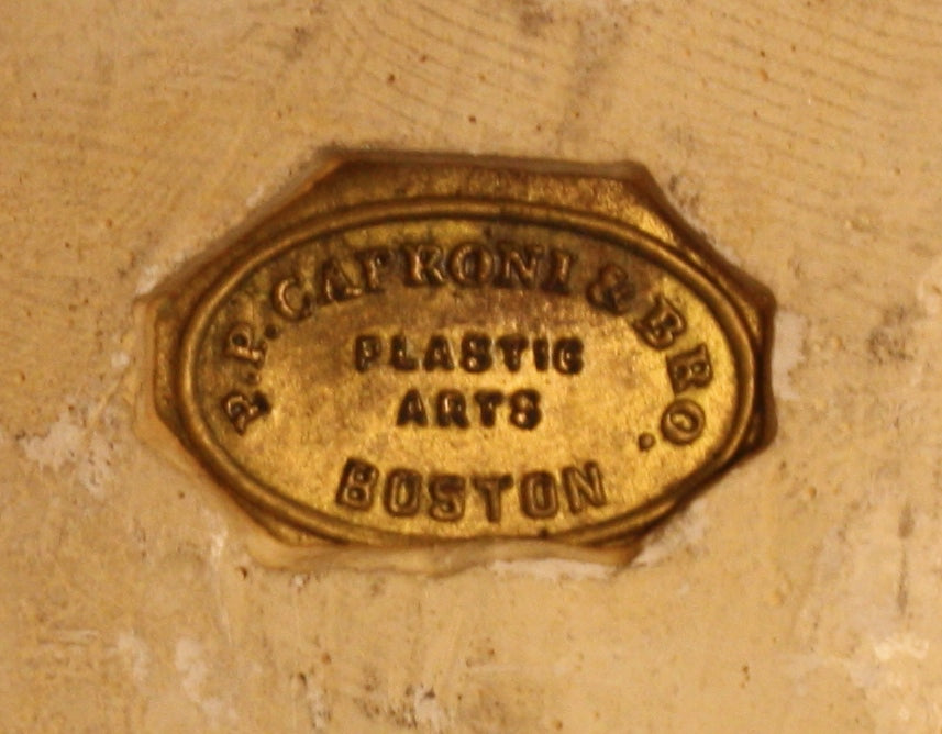 Photo of company brass hallmark in a plaster cast sculpture