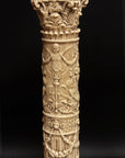 photo of plaster cast of ornamental tan-colored candlestick with black background