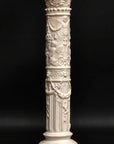 photo of plaster cast of ornamental ivory-color candlestick with black background