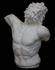 photo with black background of plaster cast sculpture of male torso and head with curly hair and beard, namely Laocoon