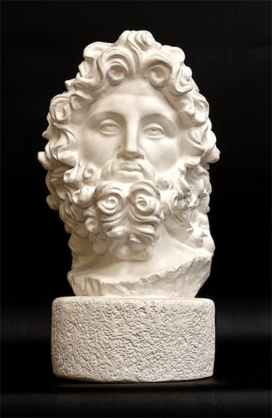 Photo with black background of plaster cast sculpture of male bust, namely the god Zeus, with curly hair and beard