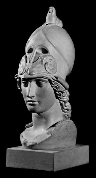 photo of plaster cast sculpture bust of female head, namely the goddess Athena, with a helmet on a black background