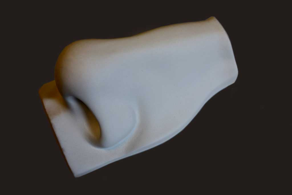 Photo of plaster cast sculpture of nose from Michelangelo&#39;s David statue on a black background