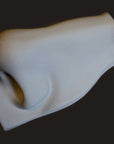 Photo of plaster cast sculpture of nose from Michelangelo's David statue on a black background