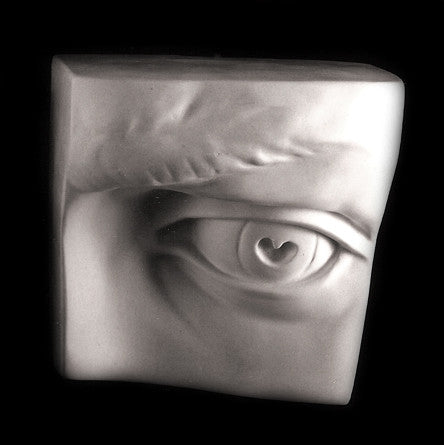 Photo of plaster cast sculpture of left eye on panel from Michelangelo&#39;s David statue on a black background