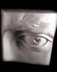 Photo of plaster cast sculpture of left eye on panel from Michelangelo's David statue on a black background