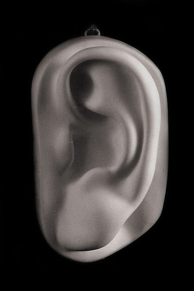 Photo of plaster cast sculpture of left ear from Michelangelo&#39;s David statue on a black background