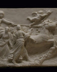 photo of a plaster cast sculpture relief of a woman, namely the goddess Aurora, flying and leading a chariot with a man pulled by horses towards the right while a cherub and other women fill the scene, on a black background