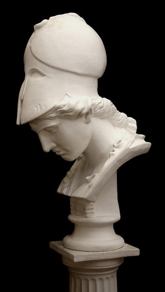 photo of plaster cast sculpture bust of female head, namely the goddess Minerva, with a helmet and looking down and placed on a pedestal with black background