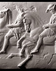 photo of off-white plaster cast relief sculpture of two men on horseback from Parthenon against black background