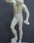 Photo with gray background of plaster cast sculpture of male faun or satyr dancing with instruments attached to his hands