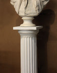 photo of plaster cast of male bust sculpture, namely Lafayette, in uniform on a Doric-like pedestal with brown background