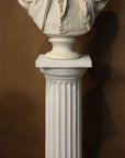 photo of plaster cast of male bust sculpture, namely Lafayette, in uniform on a Doric-like pedestal with brown background