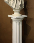 photo of plaster cast of male bust sculpture, namely Lafayette, in uniform on a Doric-like pedestal with brown background