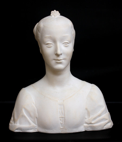 photo of white plaster cast of female bust with up-do and dress against black background