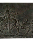 photo of bronzed plaster cast relief sculpture of two men riding horse and donkey all in profile