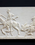 photo of plaster cast relief sculpture of two men riding horse and donkey all in profile with black background