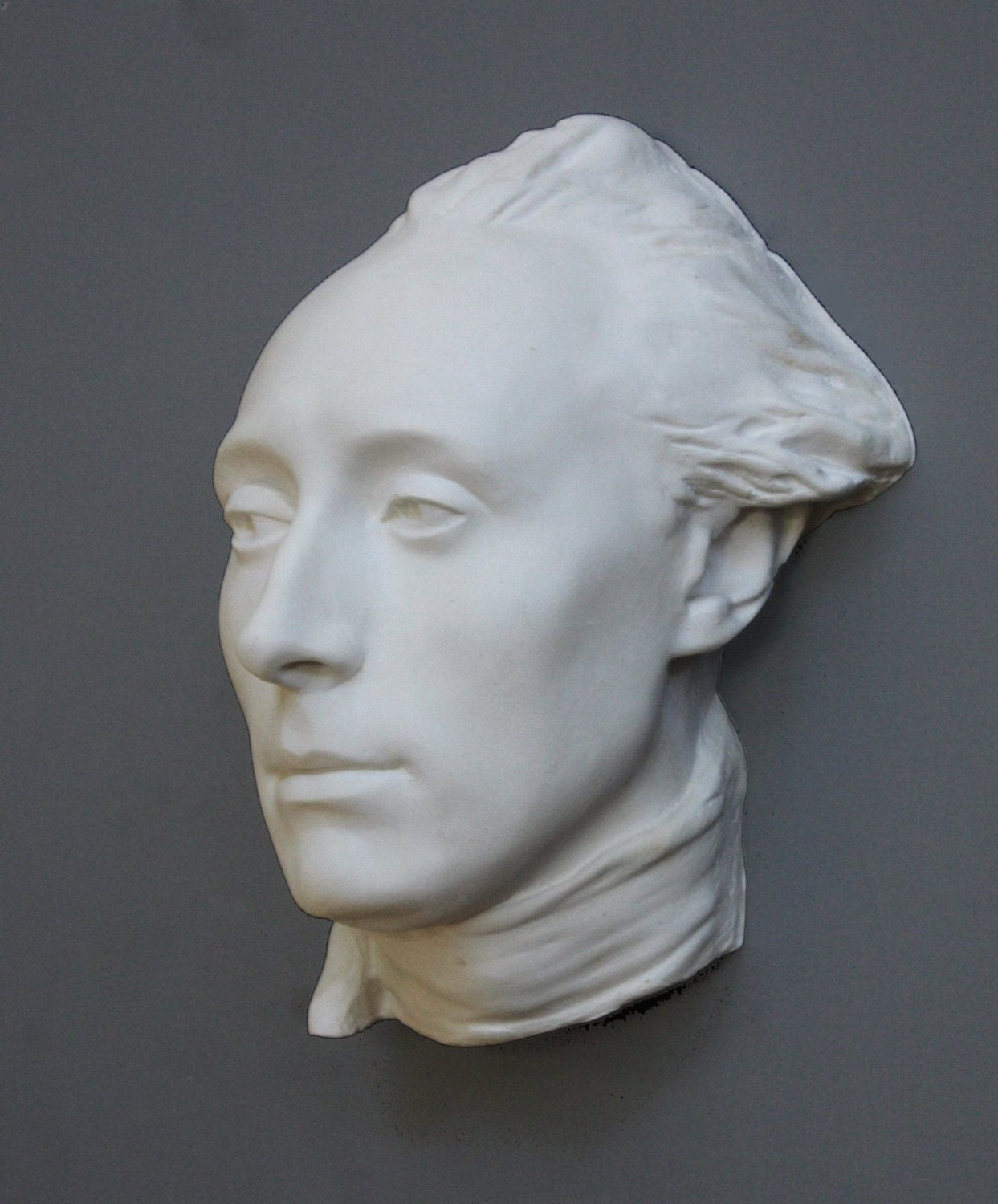 photo with gray background of plaster cast of male face, namely Lafayette, with neckerchief