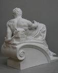 back view photo of plaster cast of reclining male nude with a gray background