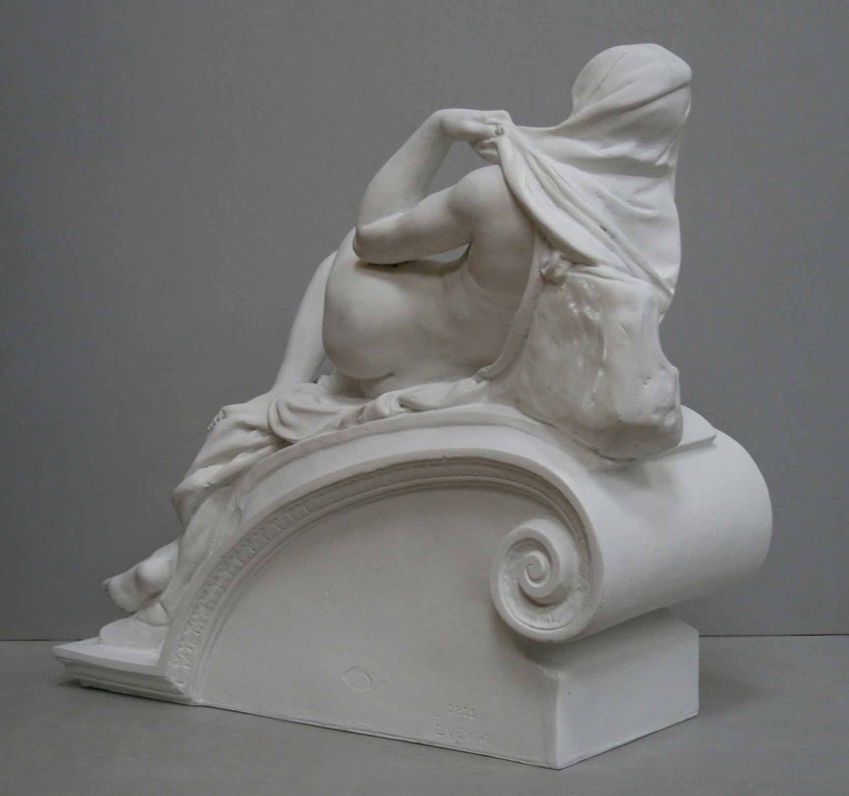 back view photo of plaster cast of reclining female nude with a gray background