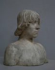 photo of plaster cast bust of man with high-neck shirt and shoulder-length hair with gray background