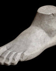 Photo of plaster cast sculpture of blocked foot on a black background