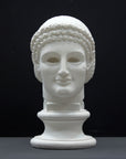 photo of plaster cast sculpture of archaic Greek male head with hair in fillet and ringlets on dark gray background