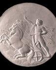 black and white photo of plaster cast relief sculpture of nude male figure in horse-drawn chariot flying