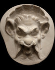 Photo of plaster sculpture of a Faun Head on a black background