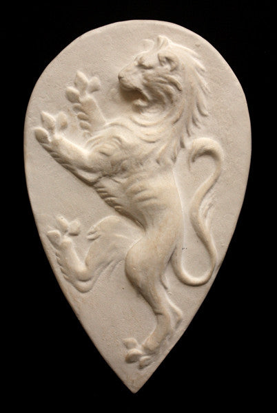 Photo with black background of plaster cast sculpture relief of lion on hind legs