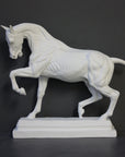 photo of white plaster cast sculpture of horse ecorche on gray background