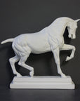 photo of white plaster cast sculpture of horse ecorche on gray background