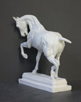 photo of white plaster cast sculpture of horse ecorche on gray background