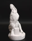 Photo of plaster cast sculpture of flayed man kneeling with hands on head on black background