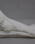 photo with gray background of plaster cast sculpture of flayed left foot on panel