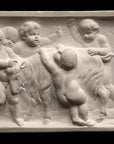 photo of plaster cast relief sculpture of several putti around a goat celebrating the god Bacchus