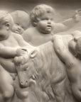 closeup photo of plaster cast relief sculpture of several putti around a goat celebrating the god Bacchus