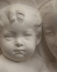 closeup photo of plaster cast sculpture relief of the Madonna holding baby Jesus