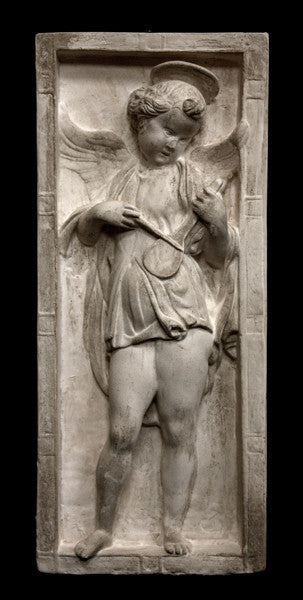 photo of yellowed plaster cast relief sculpture with angel playing a lyre on a black background