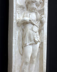 photo of plaster cast relief sculpture with angel playing a lyre on a dark gray background