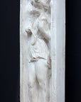 photo of plaster cast relief sculpture with angel playing a lyre on a dark gray background