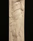 photo of plaster cast relief sculpture of female in drapery carrying jug over shoulder against black background