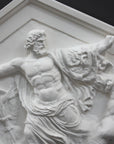 closeup photo of white triangular plaster cast sculpture relief of the god Zeus in the center and the Giants around him on a gray background