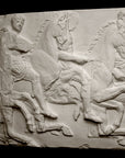 photo of off-white plaster cast relief sculpture of three men on horseback from Parthenon against black background