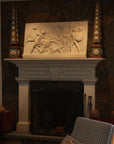 photo of plaster cast relief of men, some with armor, horses, and a dog over a fireplace with a stone wall